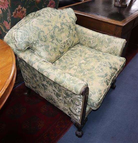 A George II design armchair upholstered in patterned green fabric